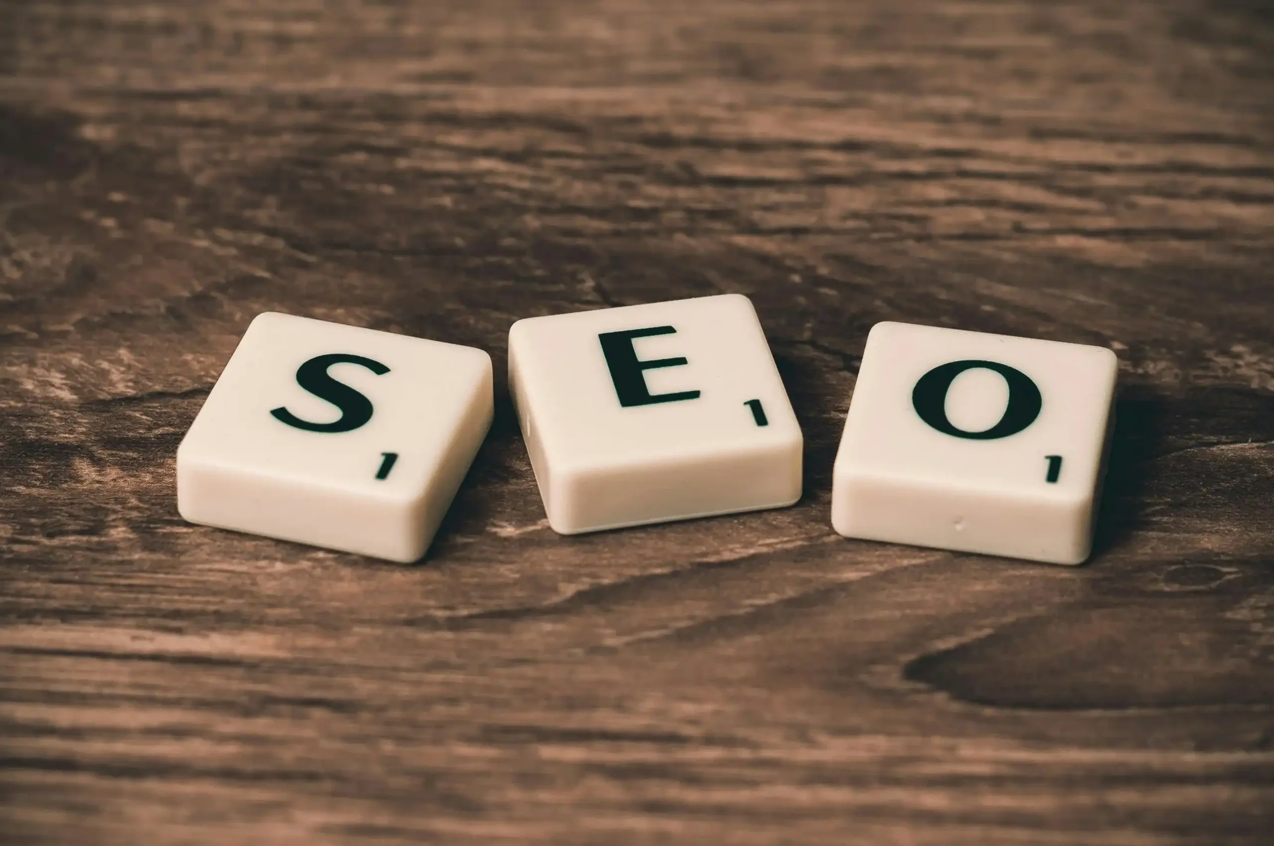 SEO letter tiles on a wooden surface, representing search engine optimization and online visibility. A visual for a Freelance Digital Marketing Analyst in Pathanamthitta helping businesses improve Google rankings, increase website traffic, and grow their digital presence.